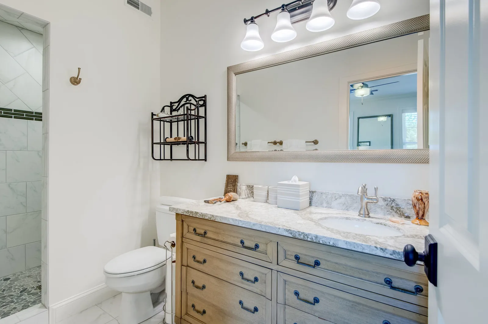 Bathroom with a wood-toned vanity and a light Cambria Beaumont quartz top
