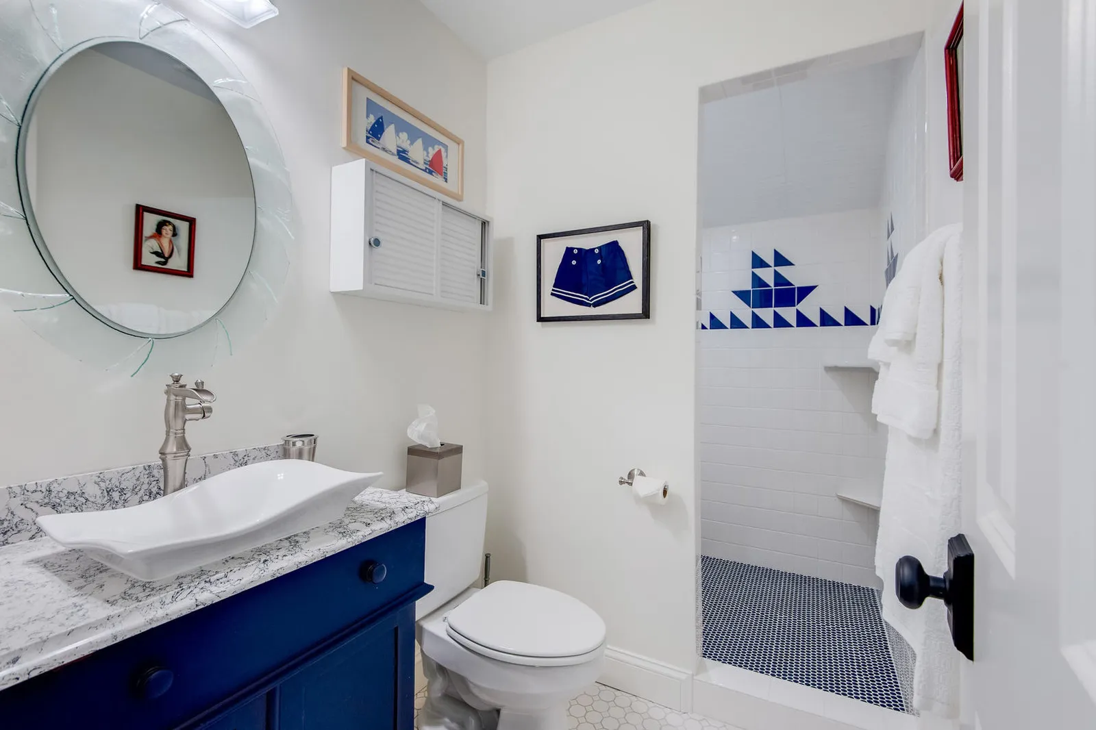 Bathroom with a navy vanity, white vessel sink and a Cambria Rose Dale quartz top